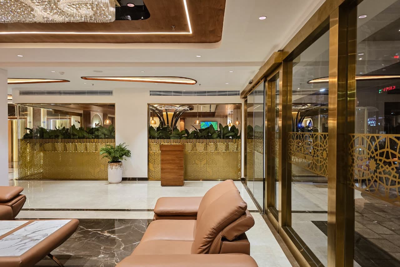 A reception lounge lit by warm cove lighting and a crystal ceiling